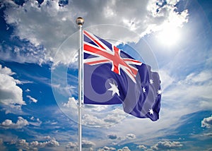 Realistic flag. 3D illustration. Colored waving flag of Australia on sunny blue sky background