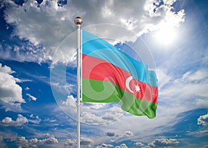 Realistic flag. 3D illustration. Colored waving flag of Azerbaijan on sunny blue sky background