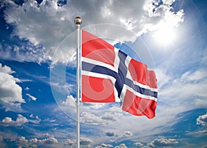 Realistic flag. 3D illustration. Colored waving flag of Norway on sunny blue sky background