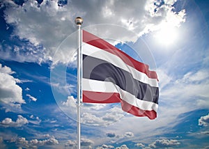 Realistic flag. 3D illustration. Colored waving flag of Thailand on sunny blue sky background