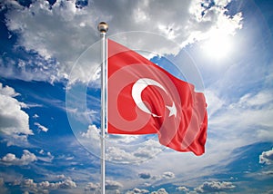 Realistic flag. 3D illustration. Colored waving flag of Turkey on sunny blue sky background