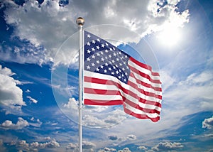 Realistic flag.3D illustration. Colored waving flag of United States of America on sunny blue sky background