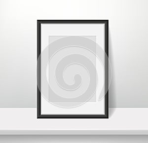 Realistic frame on wall background. Blank framed picture or poster mockup, dark plastic border with paspartu, vertical