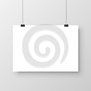 Realistic hanging blank paper sheet with shadow in A4 format and black paper clip, binder on gray background. Design