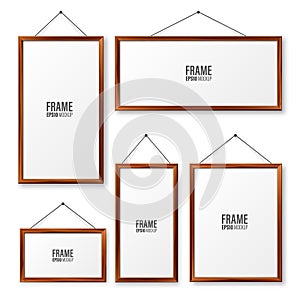Realistic hanging on a wall blank wooden picture frames set. Modern poster mockup. Empty photo frame with texture of