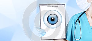 Realistic human eye with a blue cornea in the form of a round icon on a tablet in the hands of a doctor, a woman in medical