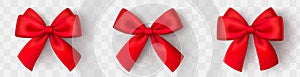 Realistic red bow. Christmas shiny red satin ribbon. New year gift. Decorative red satin ribbon and bow with shadow on transparent