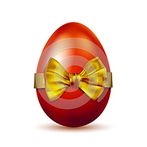 Realistic red Easter egg tied of golden ribbon with a big bow on white background