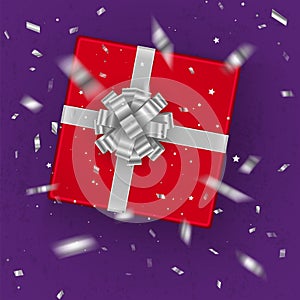 A realistic red gift box decorated with a silver bow, top view. Vector illustration