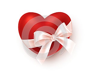 Realistic red heart with white silk ribbon bow isolated on white background. Festive design element for Happy Valentines