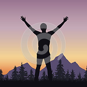 Realistic silhouette of a man welcoming sunrise in a mountain la