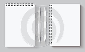 Realistic spiral notebooks. Blank notepad and pen. Vector illustration mock up for corporate identity isolated on gray