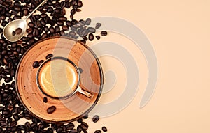 Realistic top view of black cup of espresso view from above, pastel peach color background. Cup with coffee crema and coffee beans photo