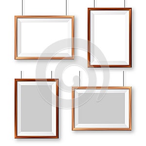 Realistic wooden picture frames with shadow isolated on white background. Hanging on a wall blank poster mockup. Empty