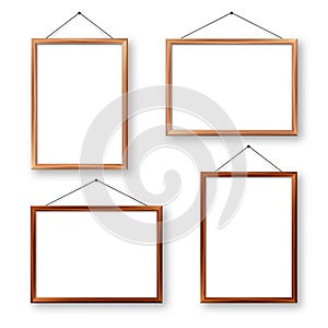 Realistic wooden picture frames with shadow isolated on white background. Hanging on a wall blank poster mockup. Empty