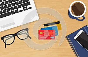 Realistic workplace with three credit cards concept of online payment and shopping