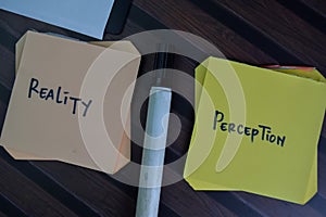 Reality or Perception write on sticky notes isolated on Wooden Table