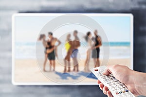 Reality tv show stream on television. Watching series on VOD streaming service. Couples at the beach or island dating.