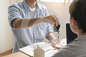 Realtor agent giving keys to tenant after sign agreement to rent property