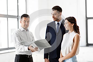 Realtor with folder showing documents to customers