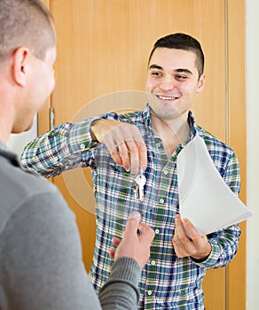 Realtor giving keys to flat owner