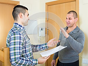 Realtor giving keys to flat owner