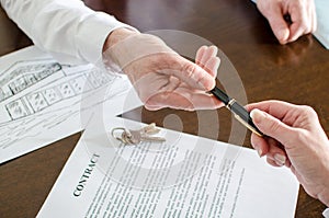 Realtor giving a pen for signature