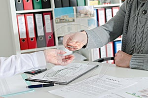 Realtor handing the keys to his client