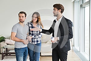 Realtor or landlord showing house apartment to young couple