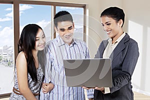 Realtor presenting new house to couple