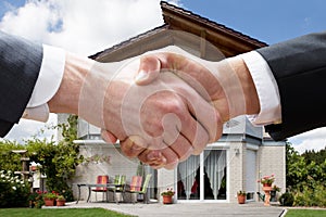 Realtor Shaking Hands With Client After Selling House