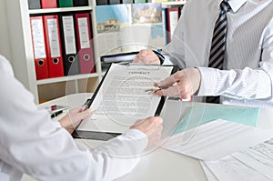 Realtor showing an estate contract and the keys to his client