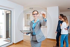 Realtor showing keys to new apartment