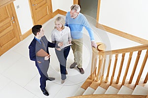 Realtor Showing Mature Couple Around House For Sale