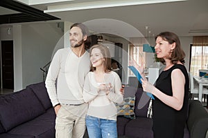 Realtor showing property for sale to young married couple