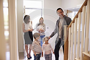 Realtor Showing Young Family Around Property For Sale