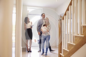 Realtor Showing Young Family Around Property For Sale photo