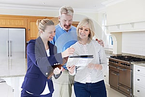 Realtor Shows Mature Couple Around House