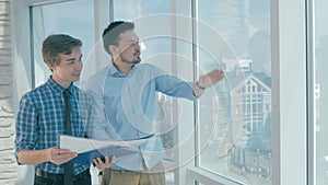 Realtors discussing construction project in a modern office.