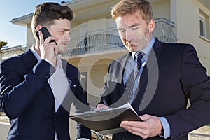 realtors standing outside modern house