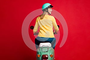 Rear back behind view of her she nice attractive cheerful cheery girl driving moped new purchase buying buyer owner