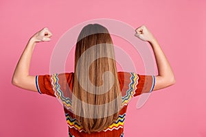 Rear behind photo of confident person hands flex show biceps nice shiny hair isolated on pink color background