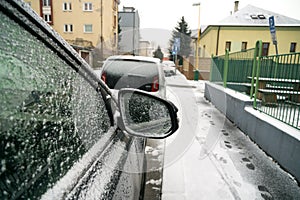 Rear car mirror with snow during winter. Slovakia