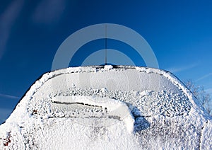 Rear car window covered with ice