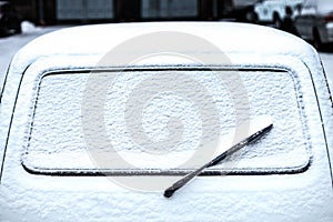 Rear car window with wiper in the snow