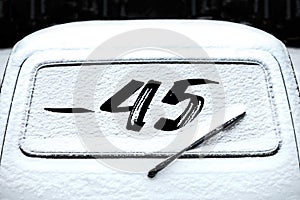 rear car window with wiper in the snow