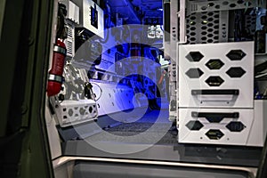 Rear cargo interior of armoured tactical truck illuminated with blue light