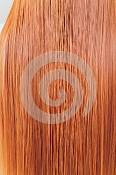 Rear closeup view of the shoulders of red haired carrot-top female.