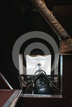 Rear dark view of cannon inside a Spanish galleon