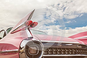 Rear end of a pink classic car